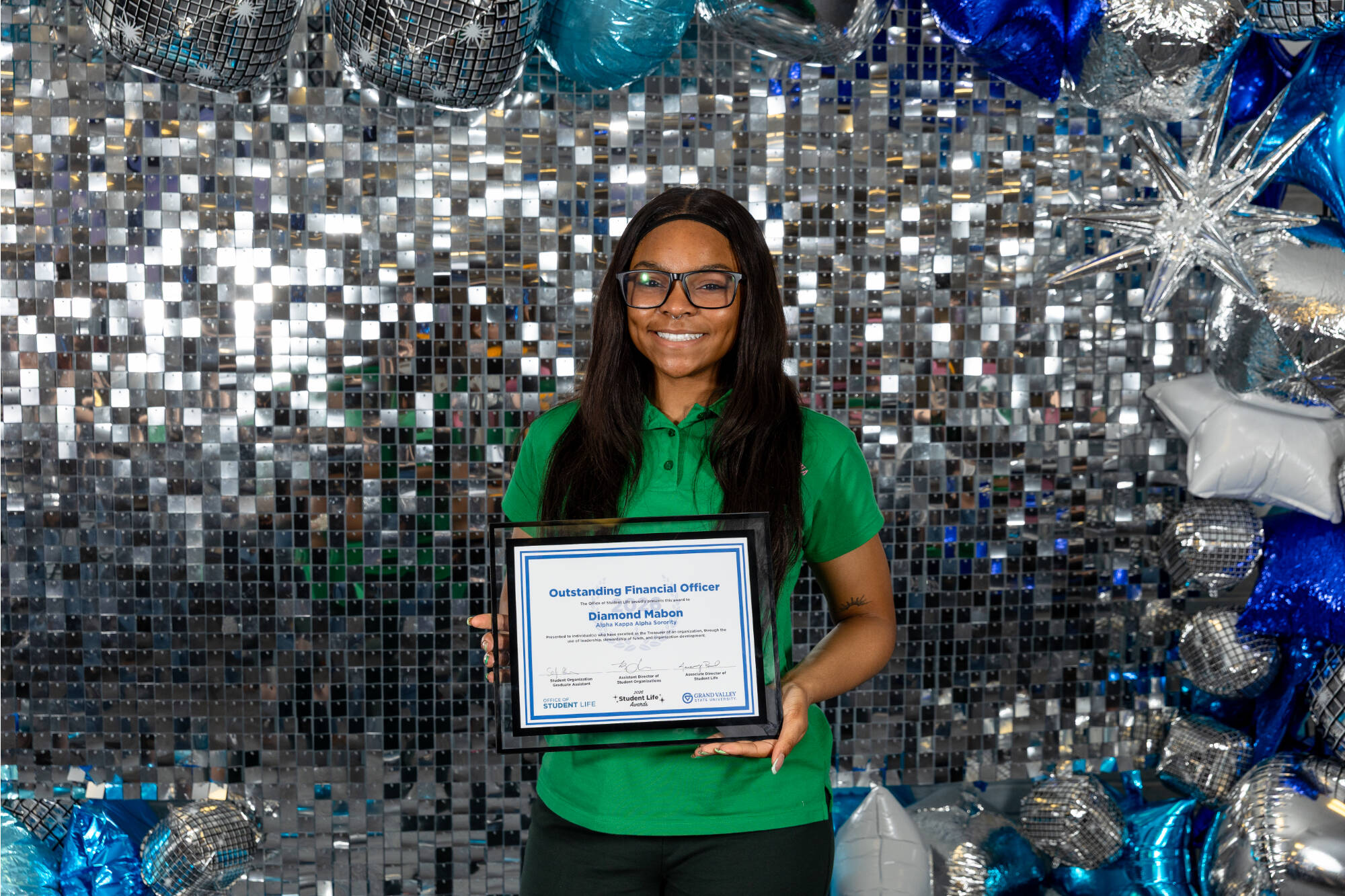 An individual holding an award certificate